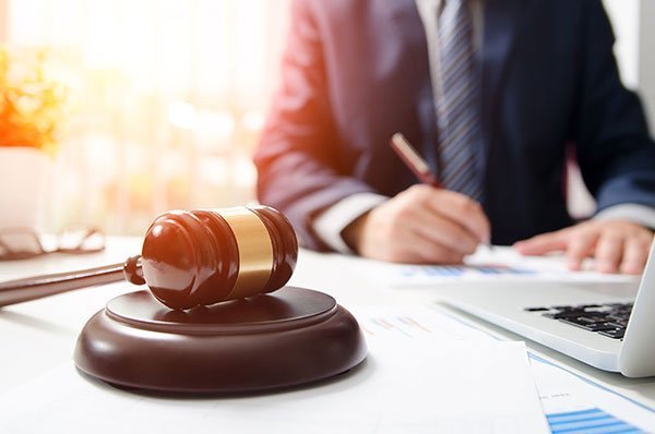 A Florida probate and trust administration attorney writing at his desk